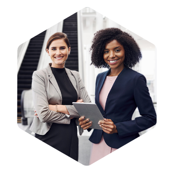 In an office, two women prepare for a pharmacometrics consultation using MonolixSuite on a tablet.