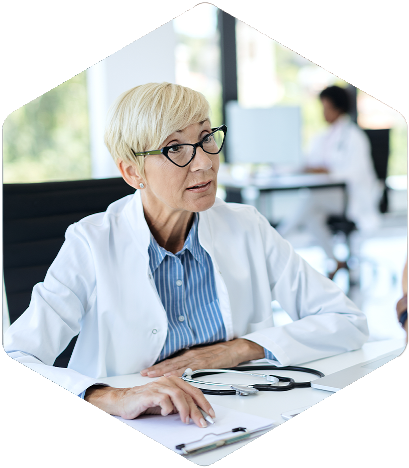 A doctor with Simulations Plus tools reviews educational materials in her bright office.