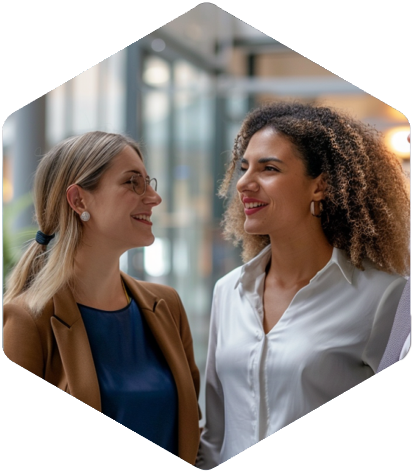 In a modern office, two women smile, reflecting passion for modeling and PK/PD adaptive learning.