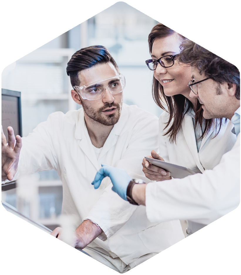 Three scientists use DILIsym® and PKPD modeling services to analyze DILI data in the lab.