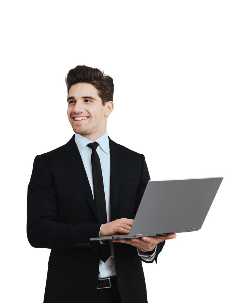 A man in a black suit smiles, typing on a laptop, exploring Simulations Plus modeling software.