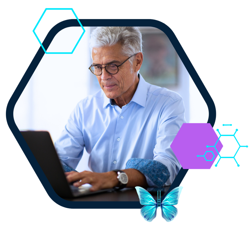 A man using DILIsym software on his laptop, amidst colorful designs and a fluttering butterfly.