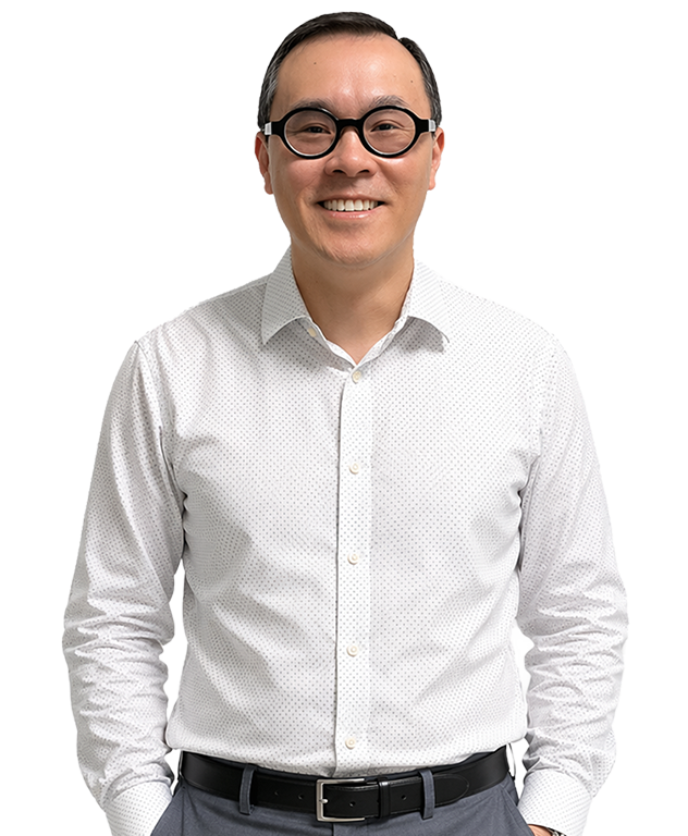A smiling man in glasses and business attire represents Simulations Plus modeling and simulation services.