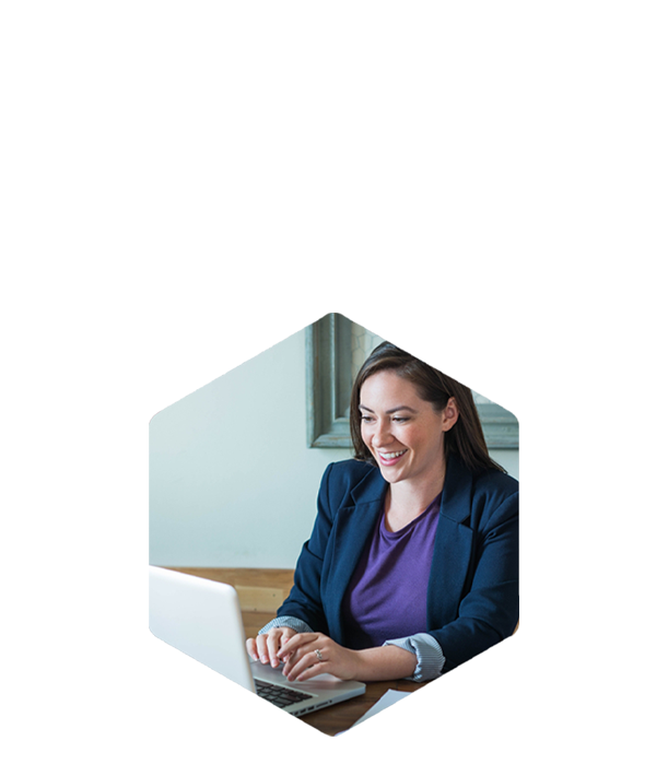 A woman smiles while using DILIsym at her desk in a bright room.